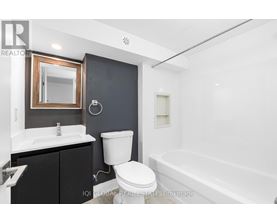A bathroom with a white toilet, sink, and bathtub.