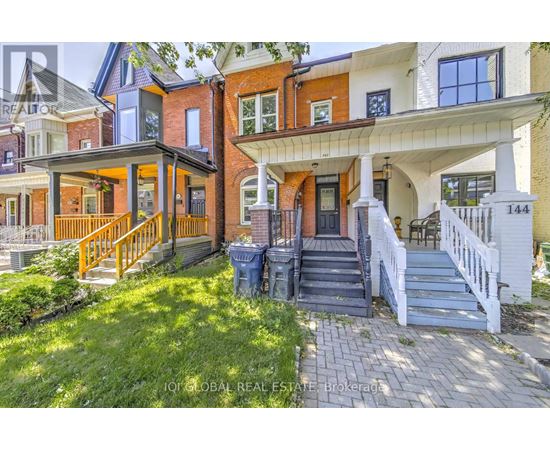 A house with a front yard and a porch.