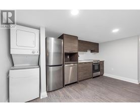 A kitchen with a white dishwasher and stainless steel appliances.