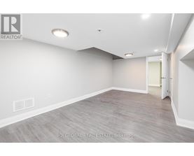 A spacious room with a door on the right side.