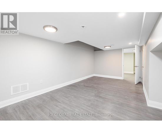A spacious room with a door on the right side.