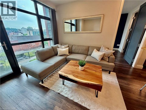 A living room with a grey couch and a wooden coffee table.