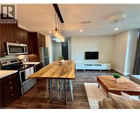 A modern kitchen with a wooden table and chairs.