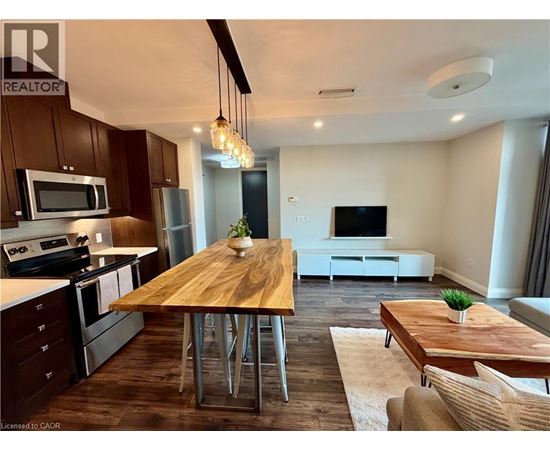 A modern kitchen with a wooden table and chairs.