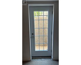 A white door with a glass window in the middle.