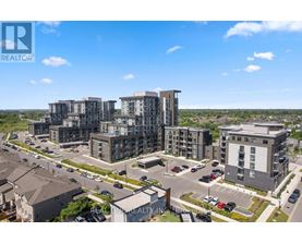 A real estate company logo is displayed on an aerial view of a residential area with modern apartment buildings.