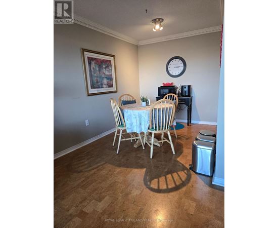 A dining room with a table set for four.
