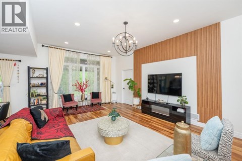 A living room with a yellow sofa and a television.