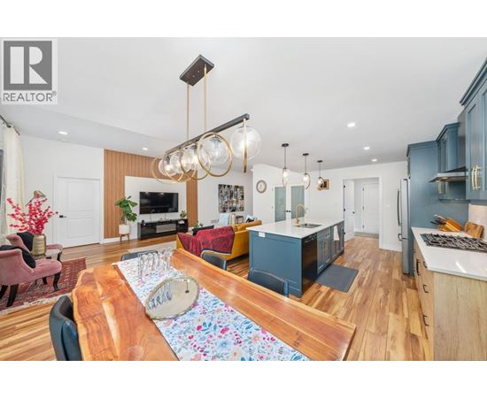 A modern kitchen with a wooden table and chairs.