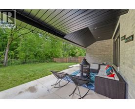 A patio with a table and chairs and a lantern.