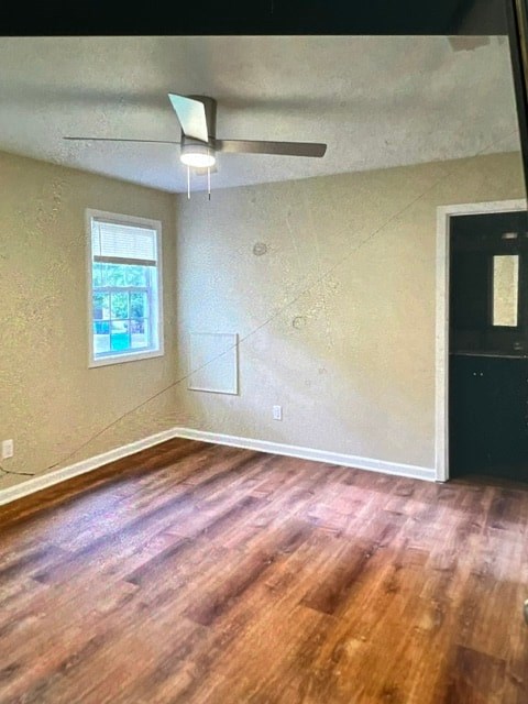 A room with a window and a ceiling fan.