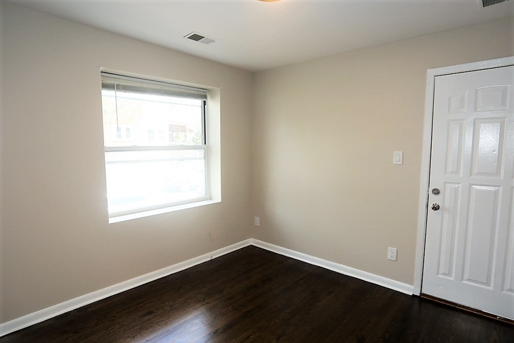 A room with a white door and a window.