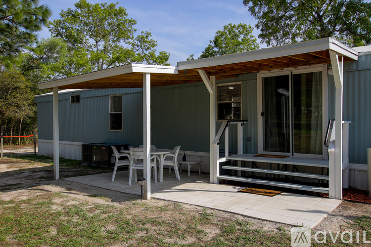 A small house with a porch and a covered patio.