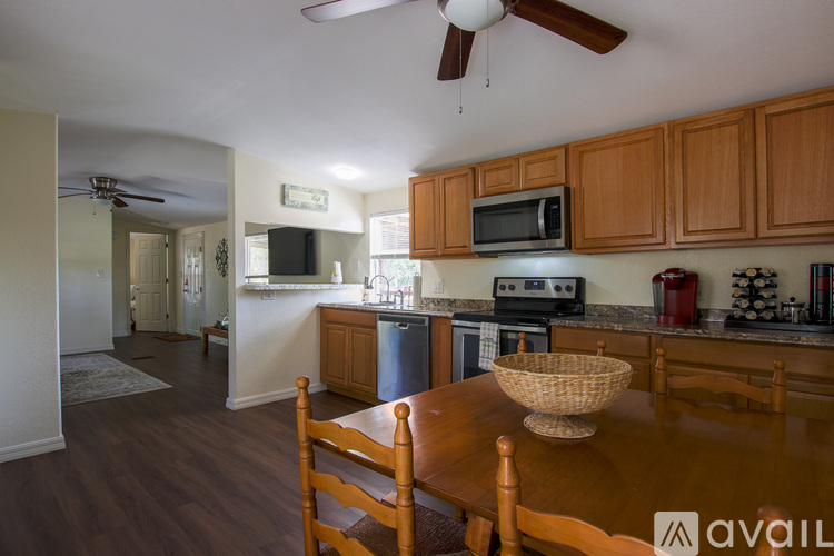 A kitchen with wooden cabinets and a table with a basket on it.