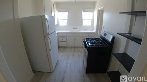 A small kitchen with a refrigerator, microwave, and a small counter.