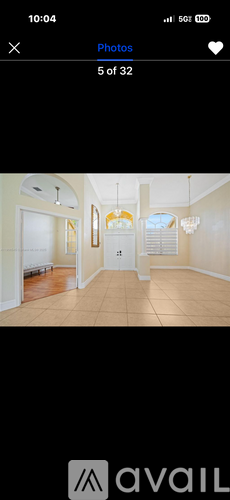 A room with a chandelier and a door.