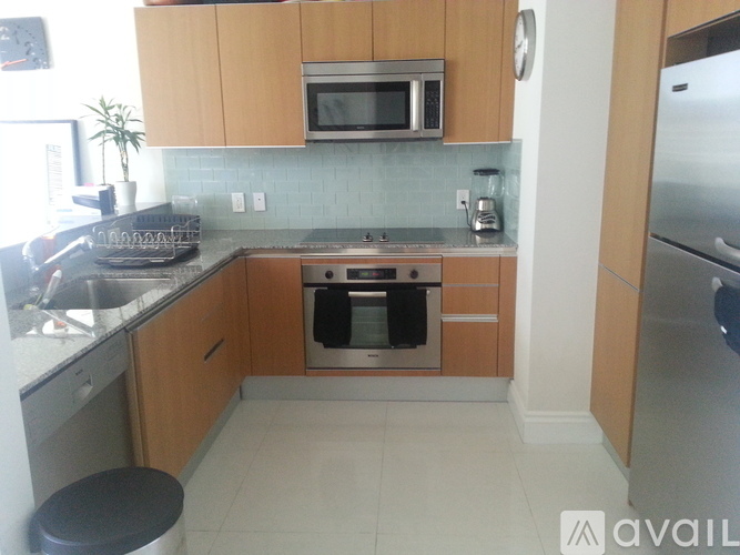 A kitchen with wooden cabinets and stainless steel appliances.
