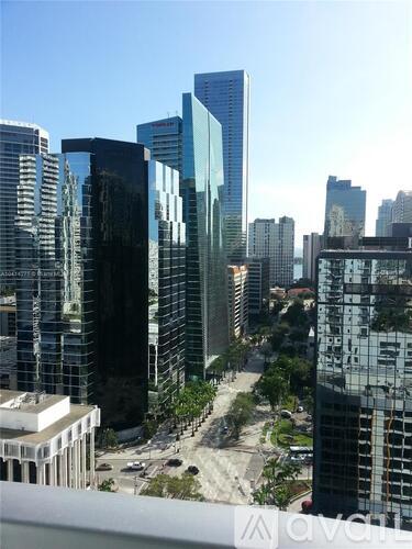 A cityscape with tall buildings and a clear sky.