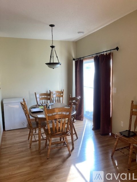 A dining room with a table and chairs.