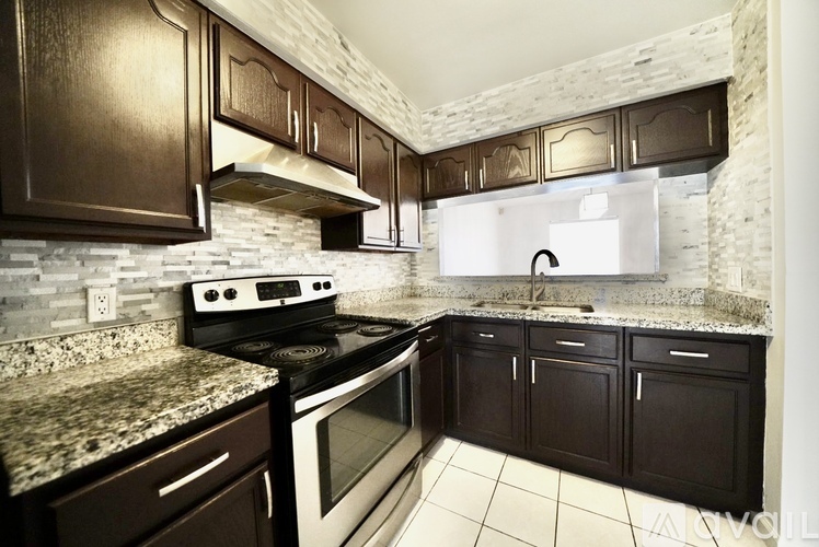 A kitchen with a stove top oven and a microwave.
