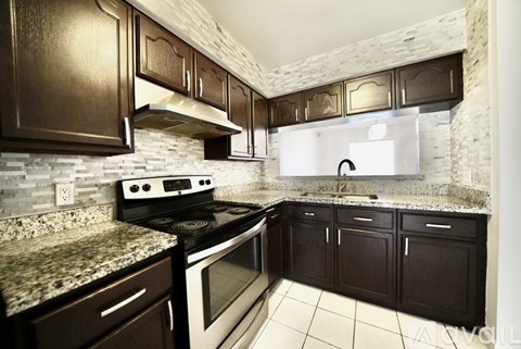 A kitchen with a stove top oven and a microwave.