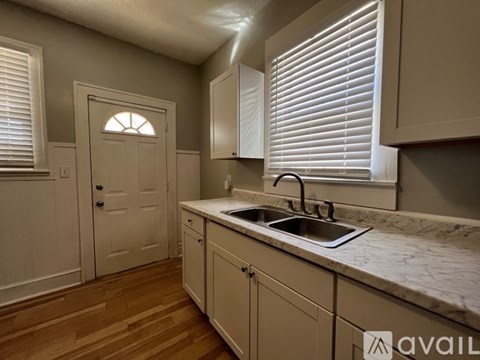 A kitchen with a sink and cabinets.