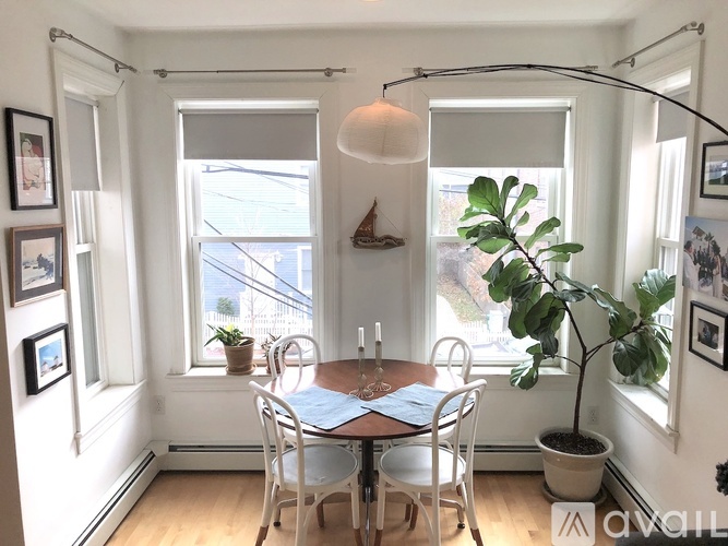 A dining room with a table and chairs.