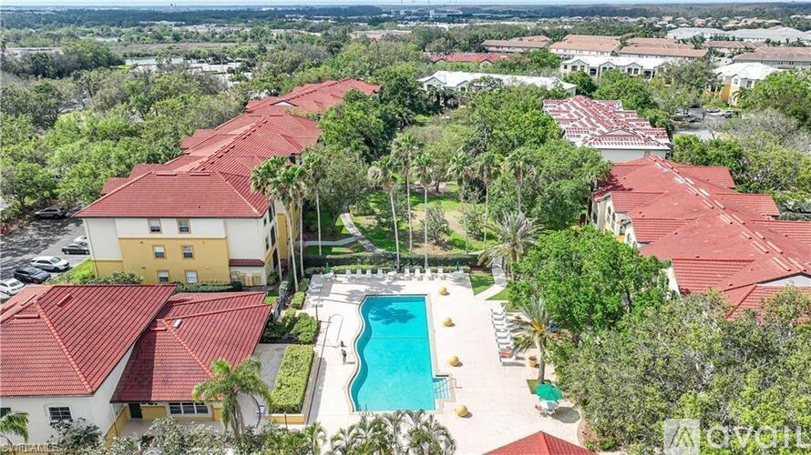 A large building with a pool in front of it.