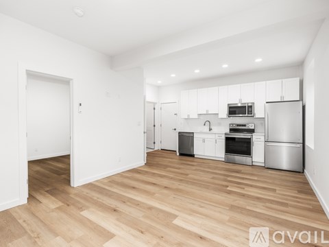 A kitchen with white cabinets and stainless steel appliances.