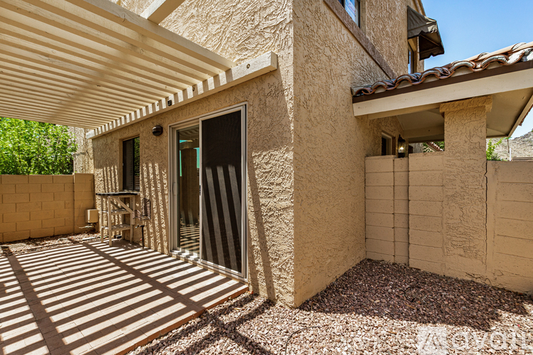 A house with a patio and a covered entrance.
