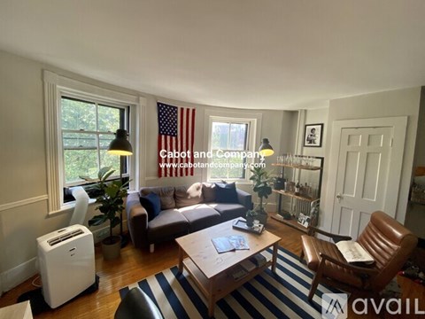 A living room with a couch, chair, and a coffee table.