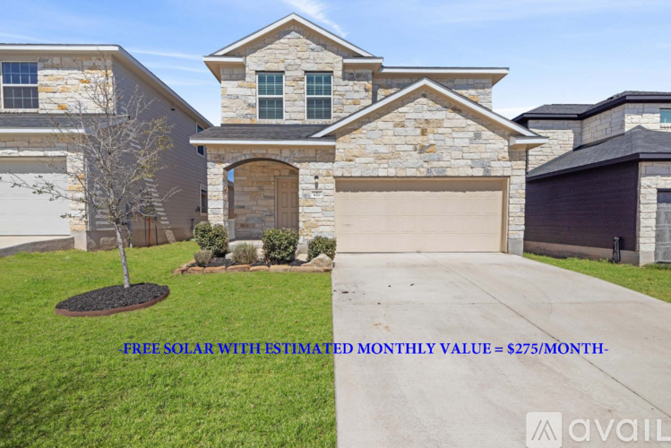 A house with a stone facade and a garage door.