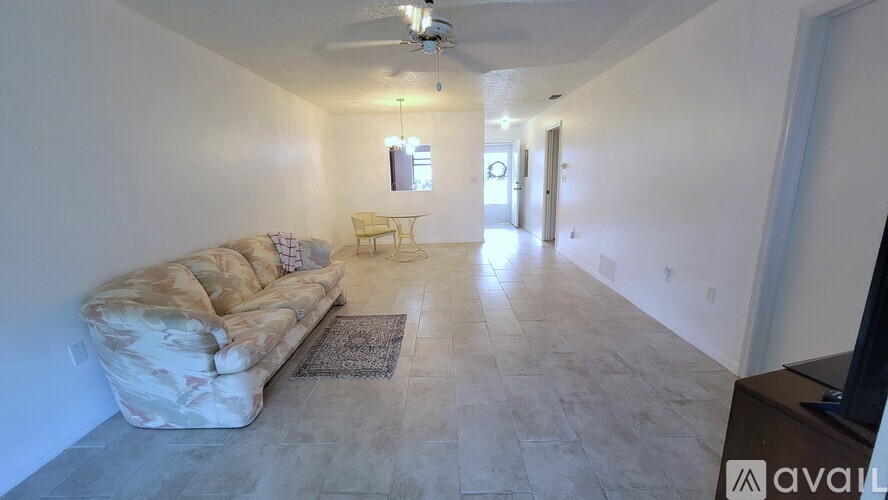 A living room with a sofa and a rug.