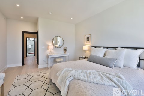 A bedroom with a large bed and a mirror on the wall.