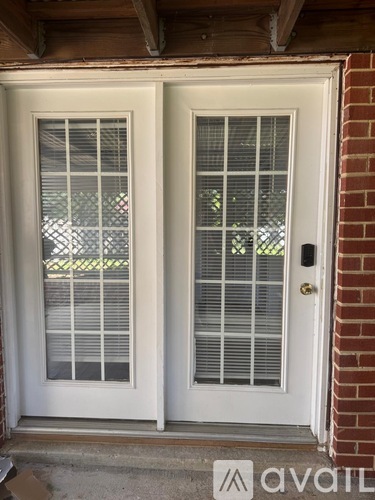 A white double door with a glass panel and a handle.
