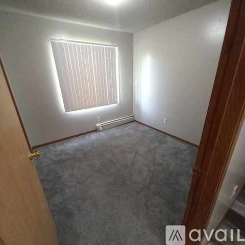 A room with a window and a radiator on the wall.
