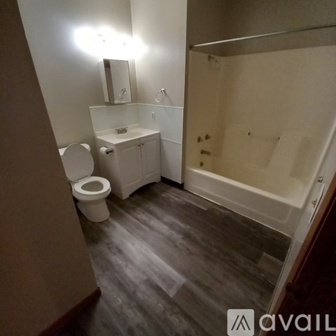 A bathroom with a toilet, sink, and bathtub.