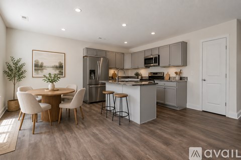 A modern kitchen with a dining table and chairs.