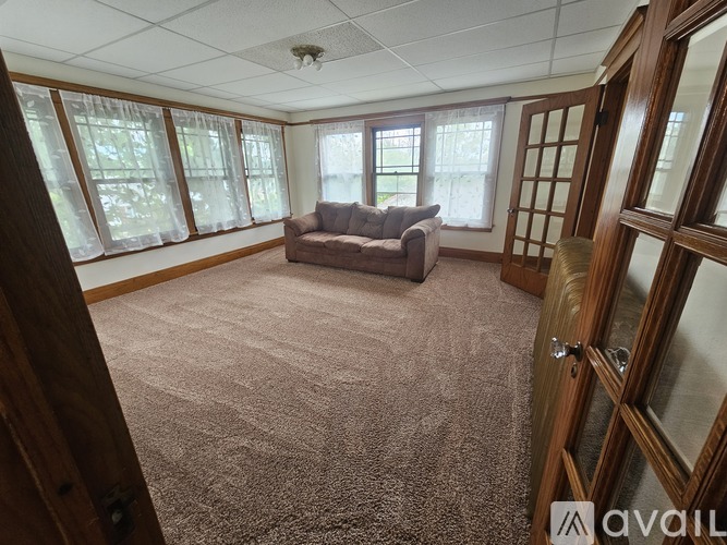 A living room with a couch and carpet.