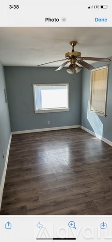 A room with a ceiling fan and a window.
