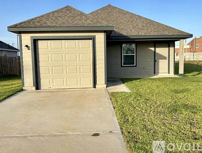 A small house with a garage door is for sale.