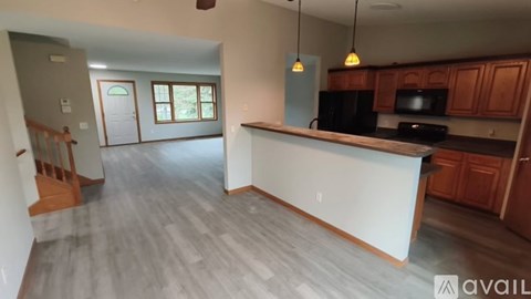 A kitchen with wooden cabinets and a black countertop.