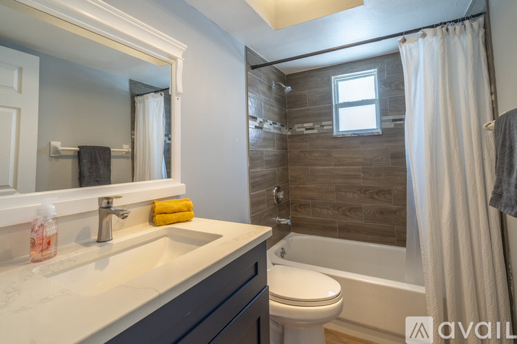 A bathroom with a white sink and a white toilet.