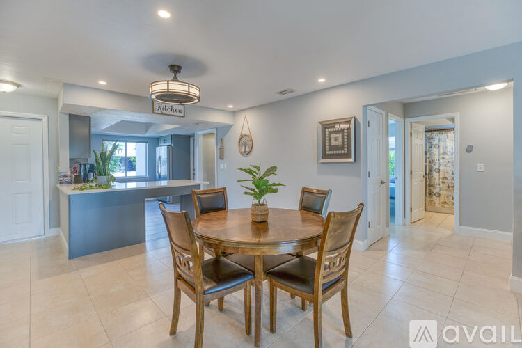 A dining room with a wooden table and chairs.
