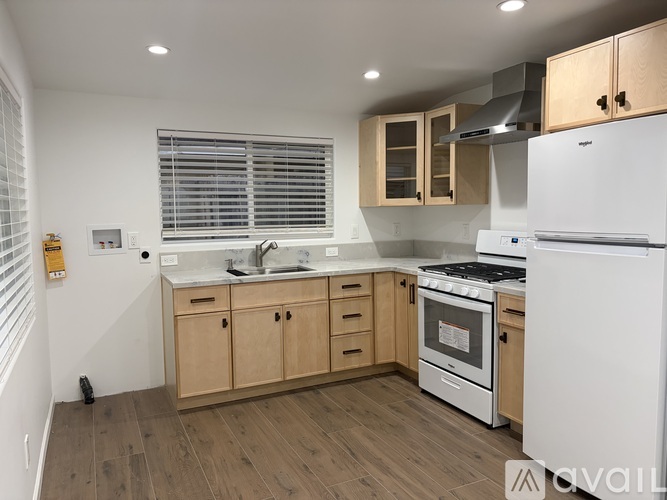 A kitchen with wooden cabinets and a white fridge.