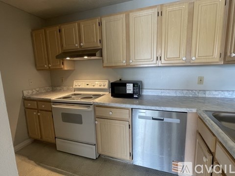 A kitchen with wooden cabinets and stainless steel appliances.
