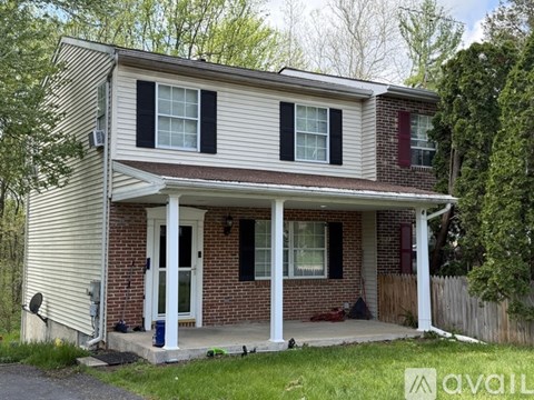 A house with a white porch and a red door.