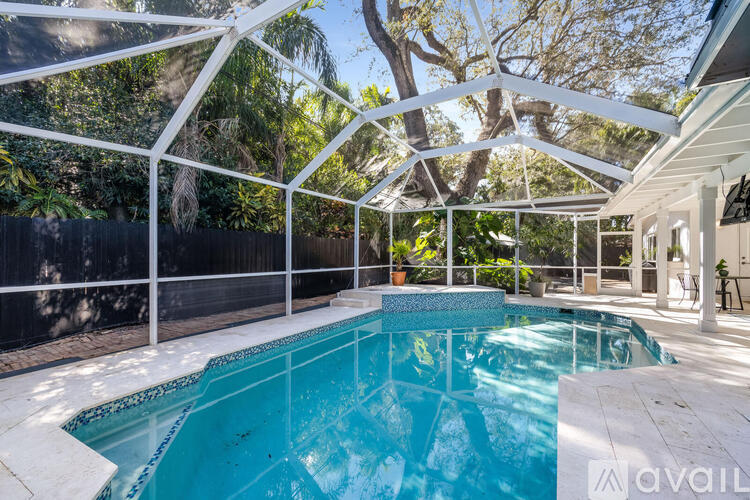 A pool enclosed by a white metal frame.