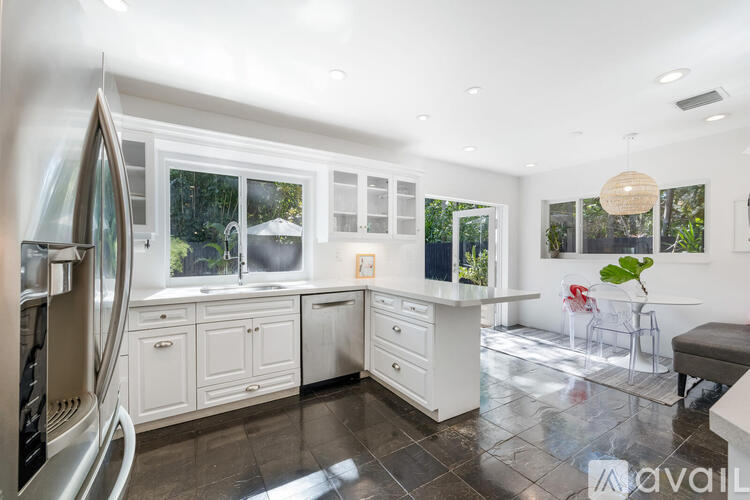 A modern kitchen with white cabinets and a large island.