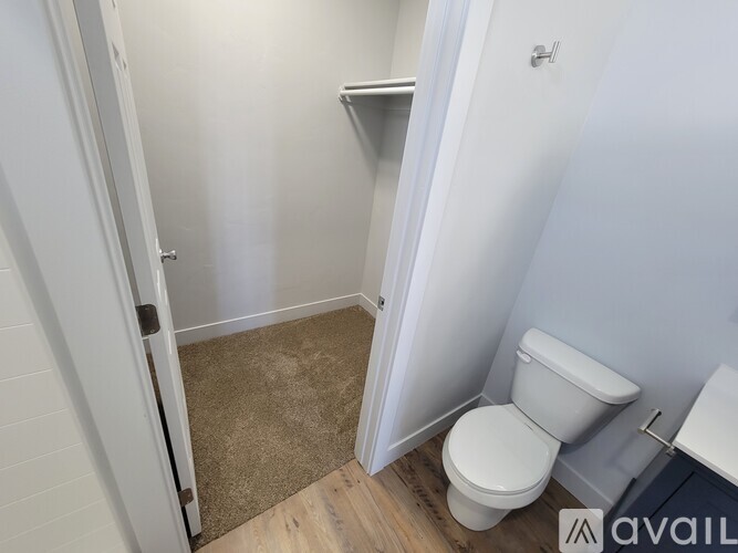 A bathroom with a toilet and a small shelf.